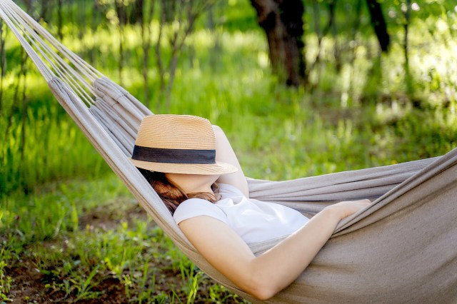 An image of a woman sleeping in a hammock