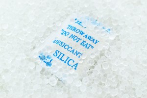 Silica packet with blue writing that reads "Throw away do not eat"