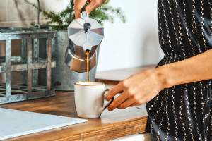 Person pouring coffee from a Moka pot