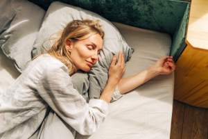 Woman lying on her side in bed