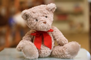 Stuffed teddy bear with a red bow