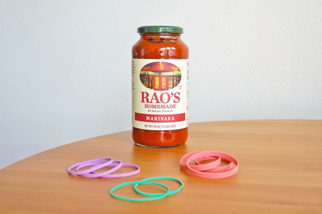 Rao's Homemade Marinara sauce jar next to a bunch of rubber bands