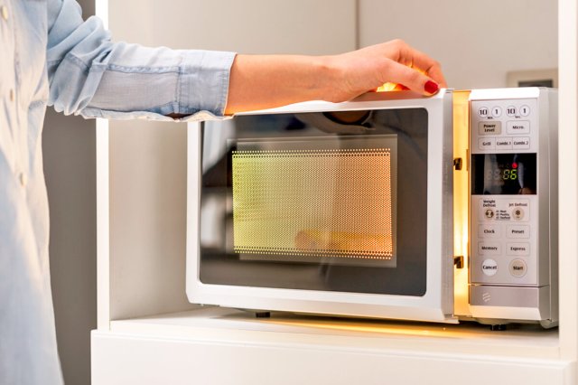 Person opening their microwave