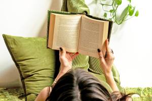 Person laying down reading a book