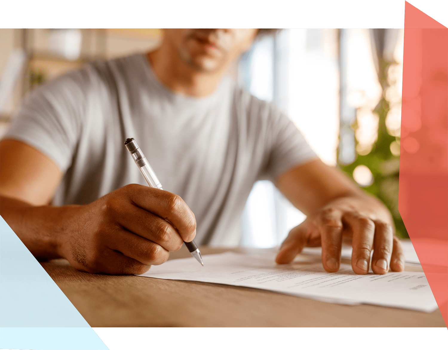 Man signing a document with a pen 