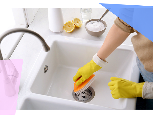 Someone scrubbing their sink with a brush 