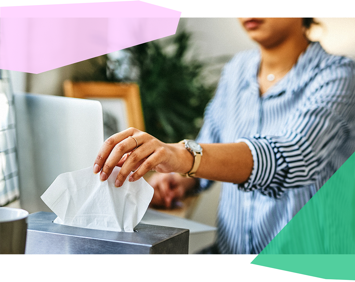 Woman grabbing a tissue from a tissue box 