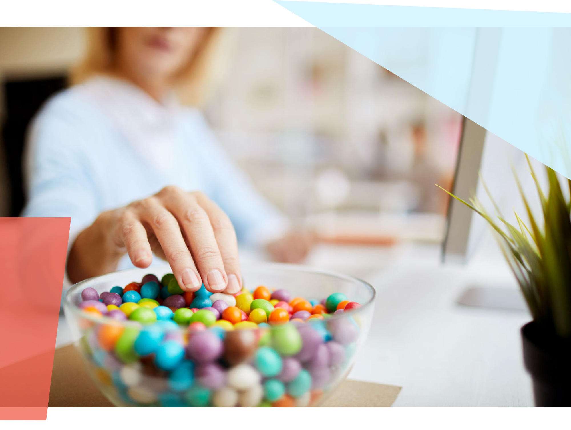 Person grabbing a piece of candy from a bowl of candy 