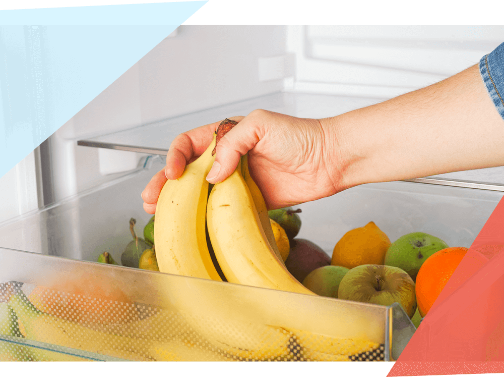 Person putting a bunch of bananas in the refrigerator. 