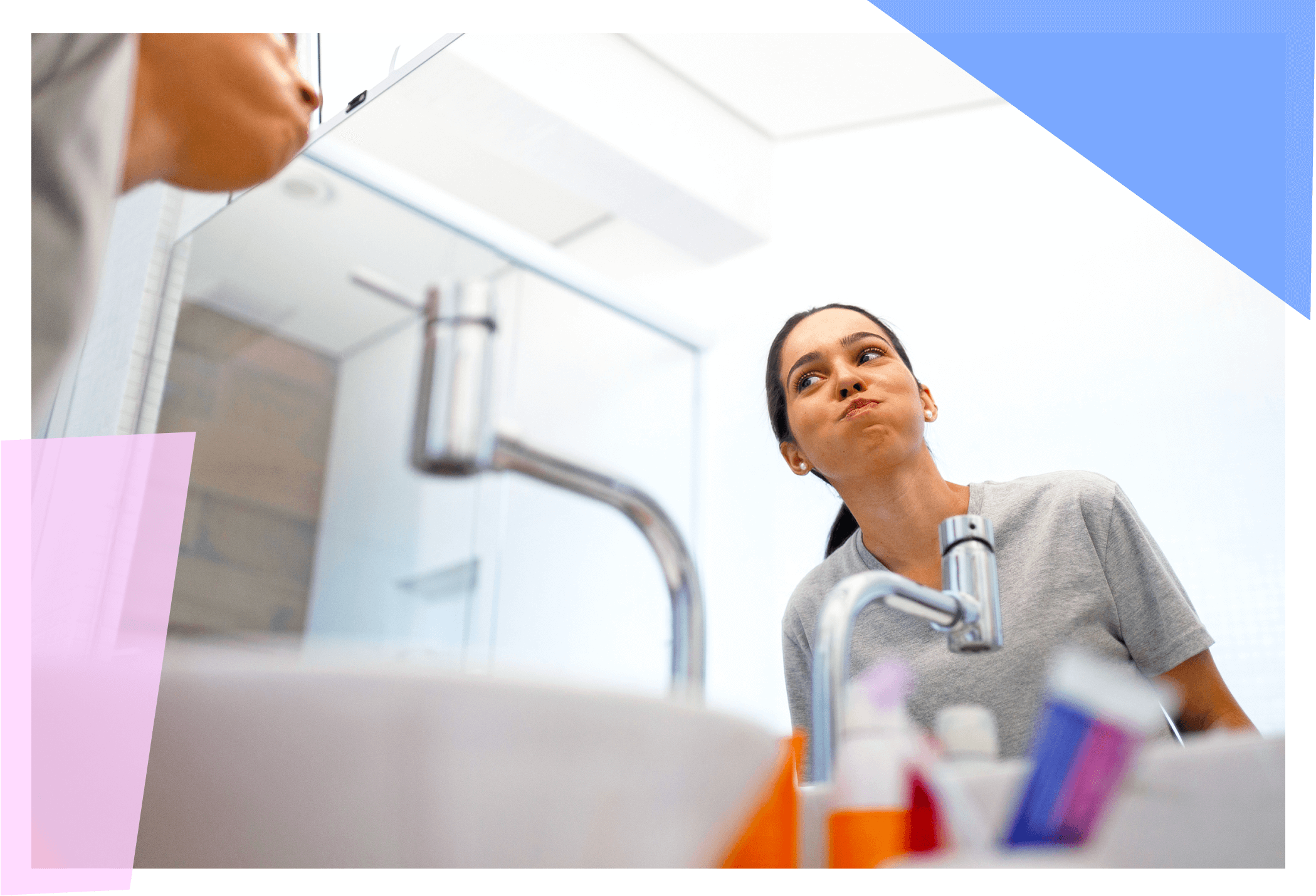 Person swishing oil in their mouth above a sink 