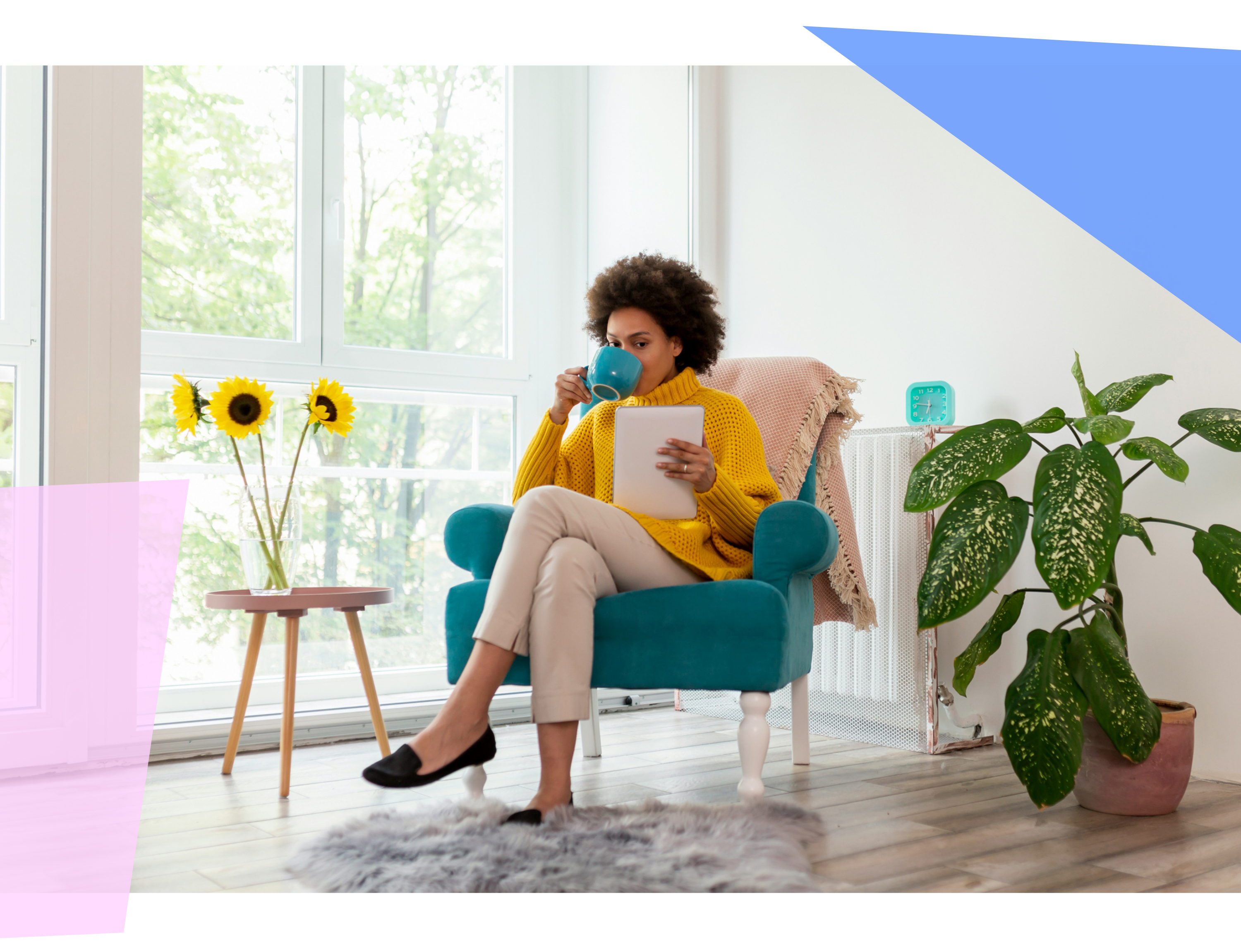 Woman drinking from a mug and reading on an e-reader 