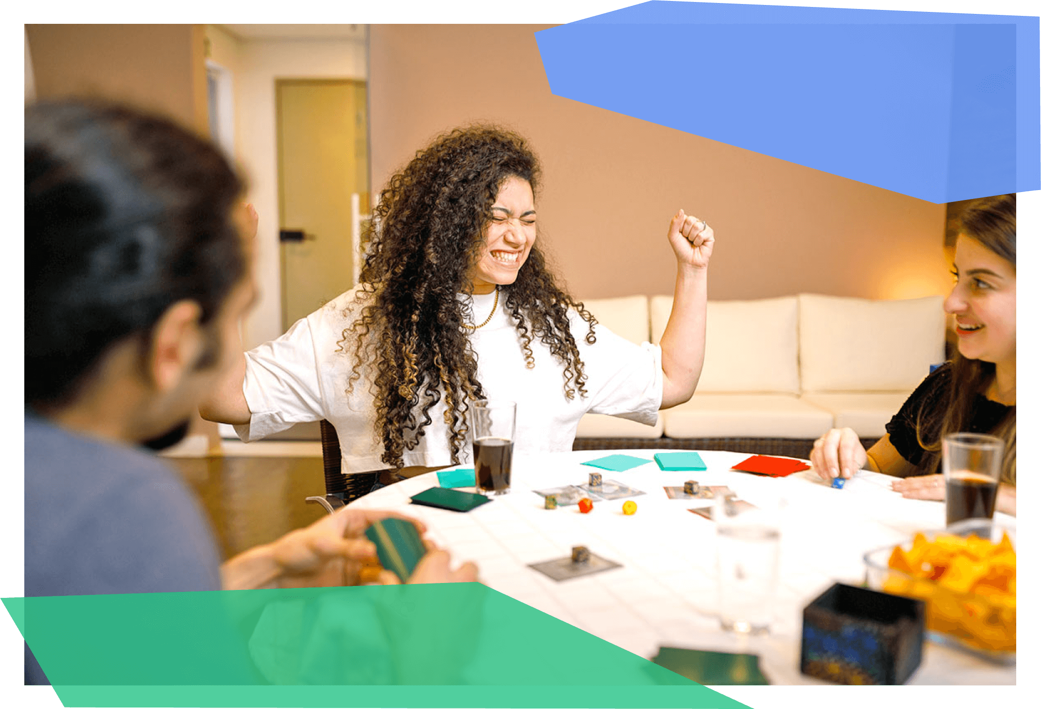 Woman cheering while playing board game with friends 