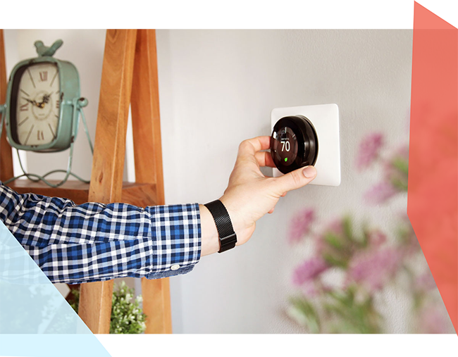 Person adjusting smart thermostat 