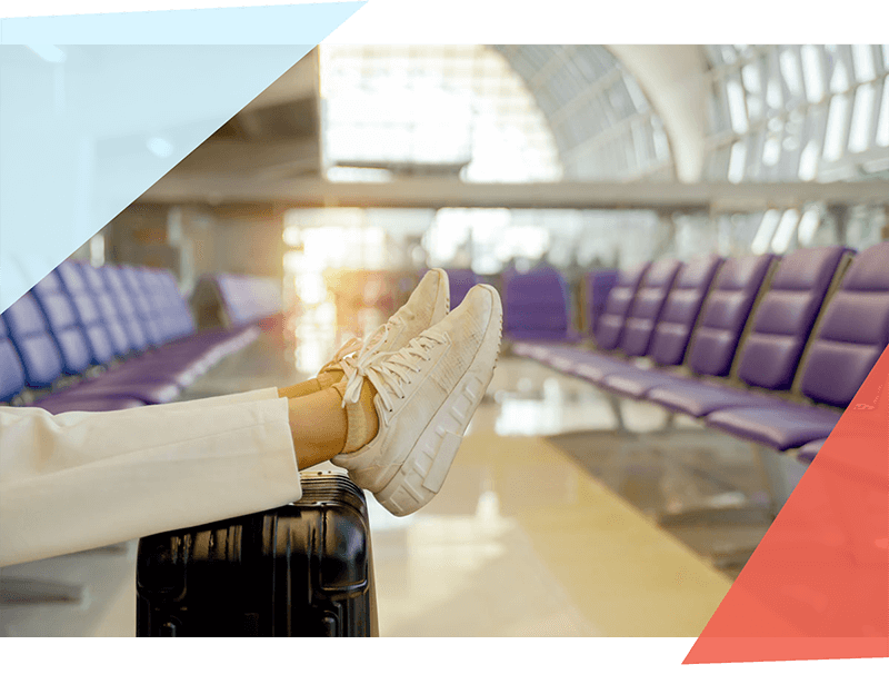 Person with feet propped up on suitcase 