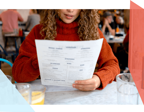 Woman reading a menu at a restaurant 