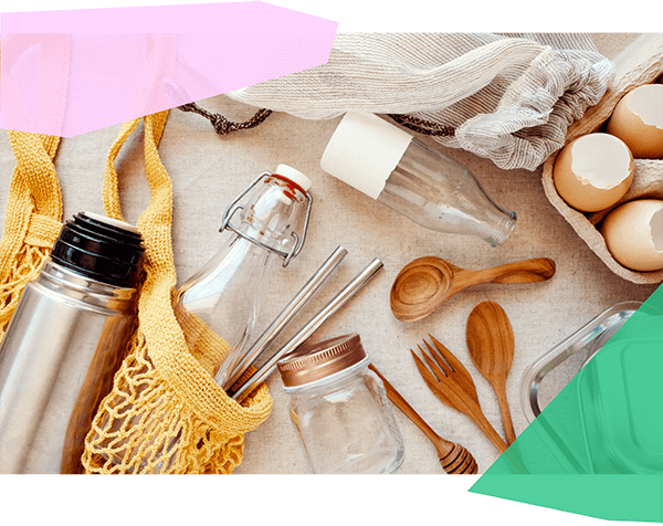 Glass bottles, steel straws, bamboo utensils, and reusable grocery totes 