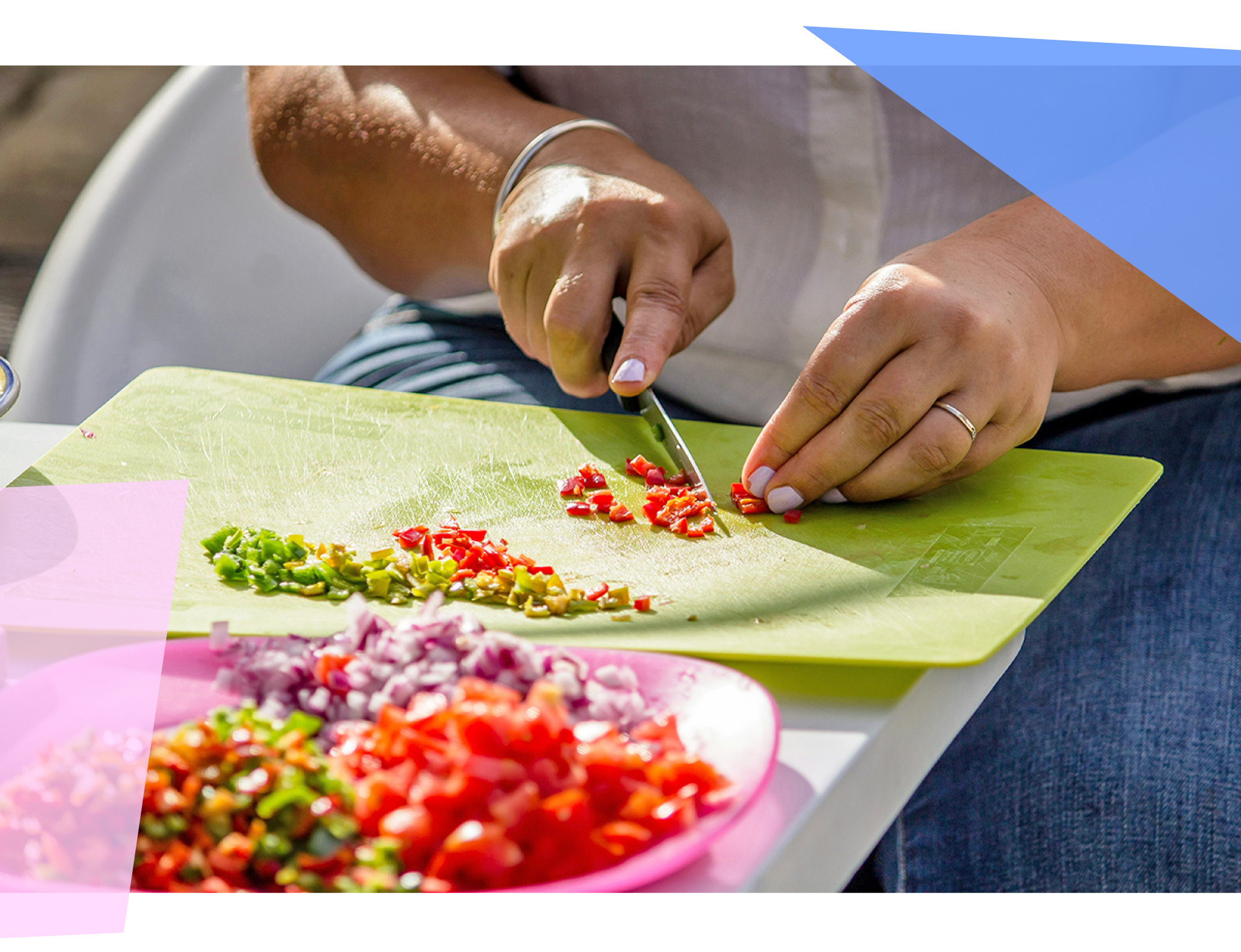 Person chopping vegetables on a green plastic cutting board 