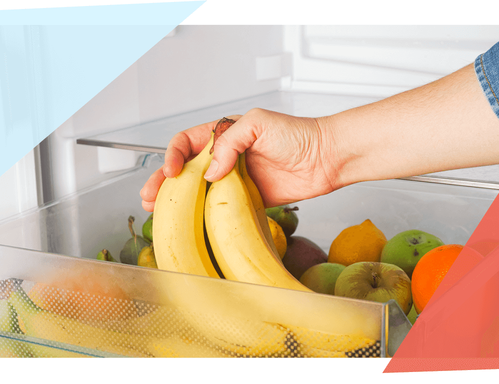 Person putting bananas in the fridge 