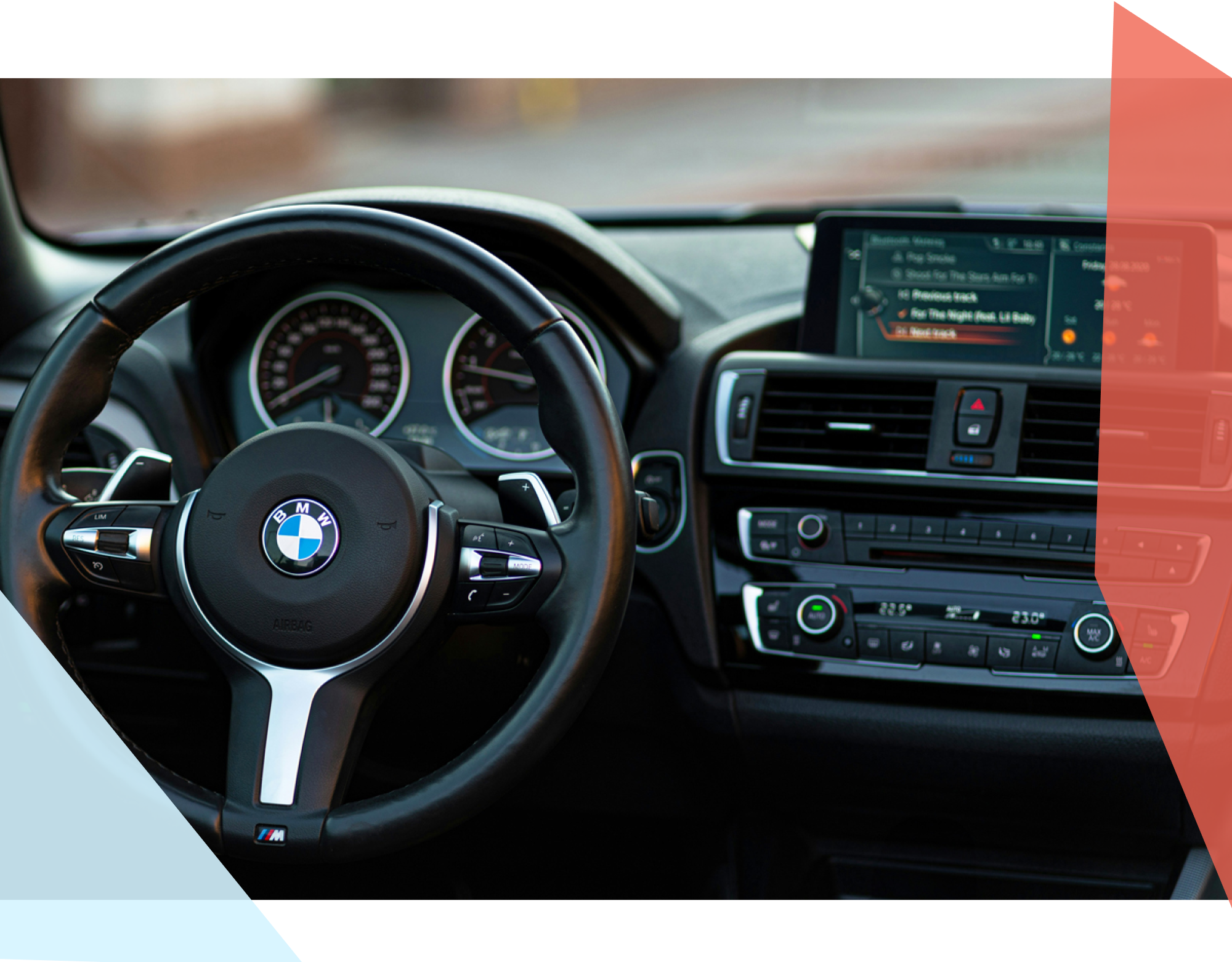 A steering wheel and dashboard of a BMW 