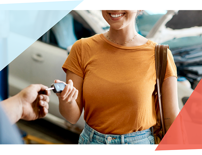 Woman handing her car keys to another person 