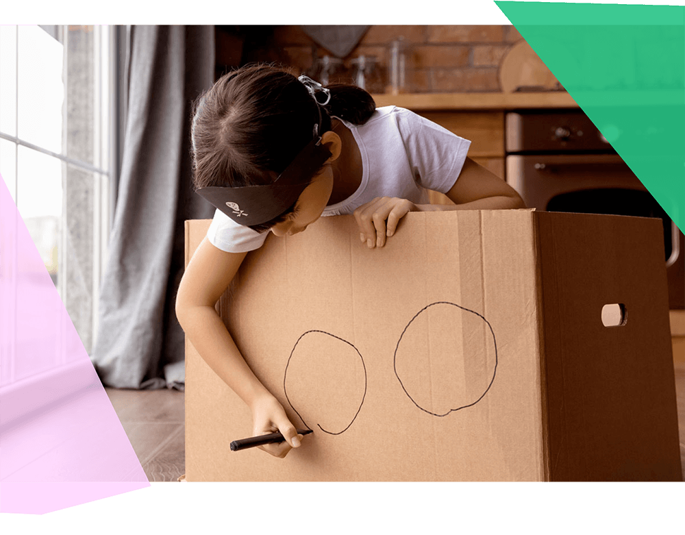 A child drawing circles on cardboard 