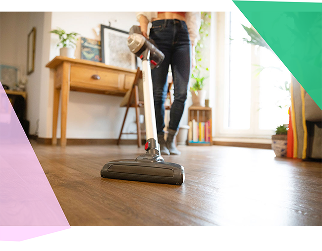 Person vacuuming hardwood floor