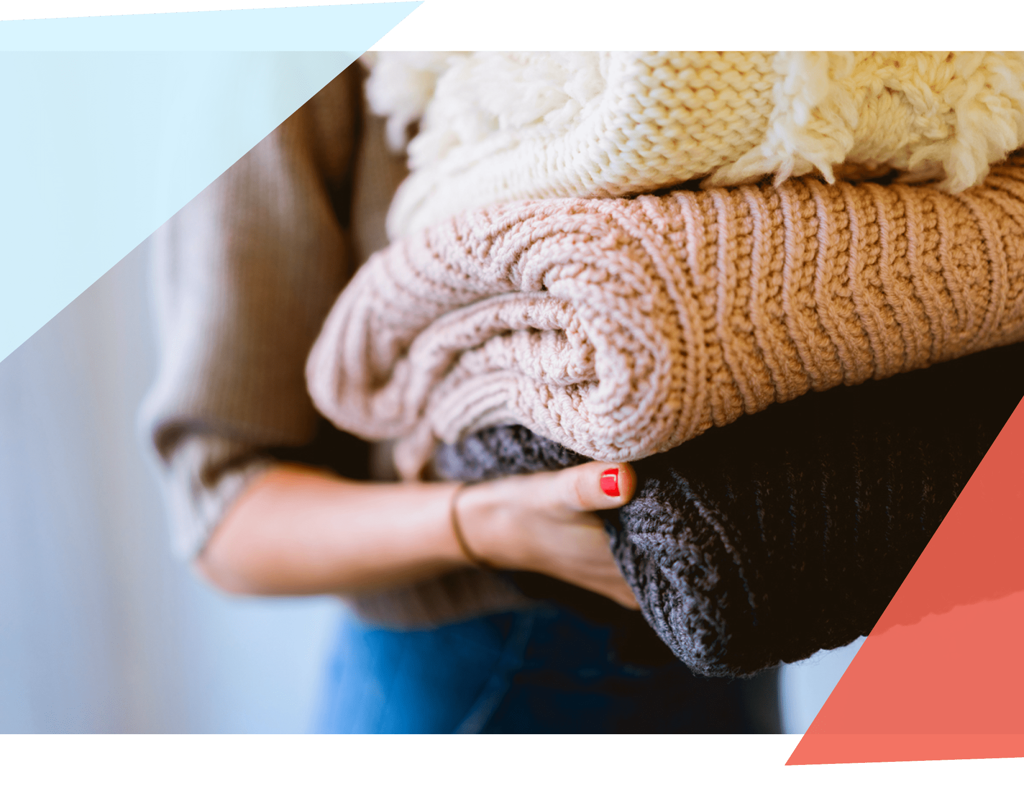 Person carrying pile of folded bulky laundry 