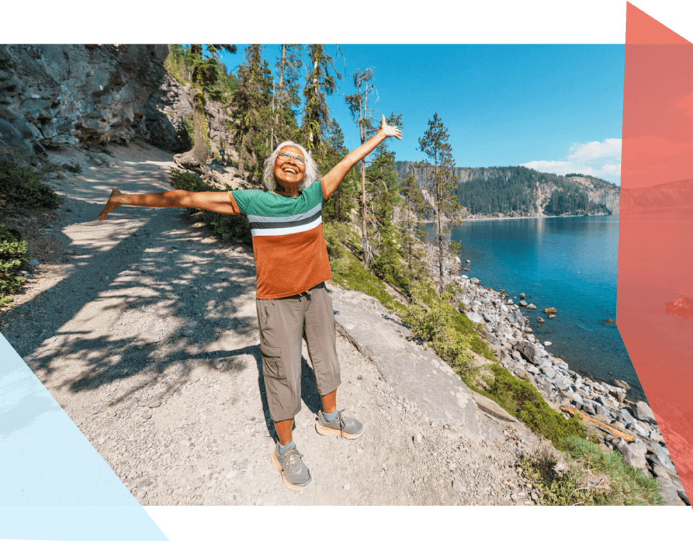 Person smiling while hiking outside near water 