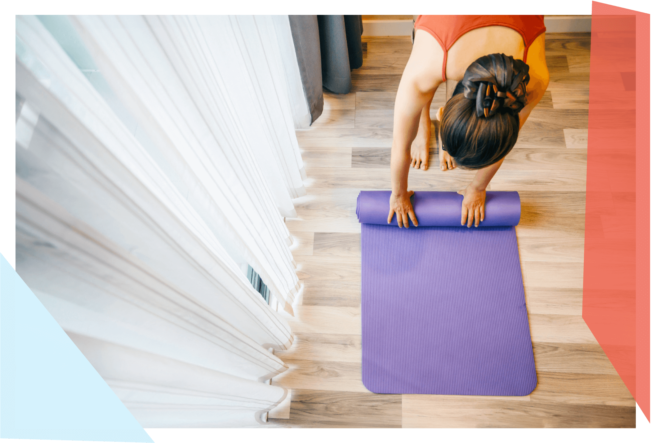 Woman rolling up yoga mat 