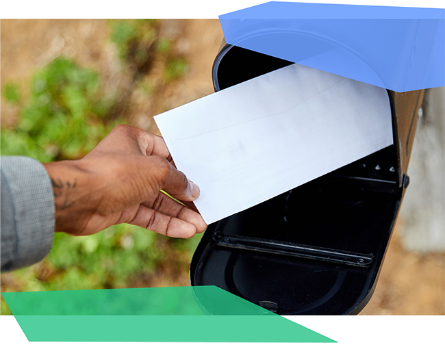 Person putting a letter in a mailbox 