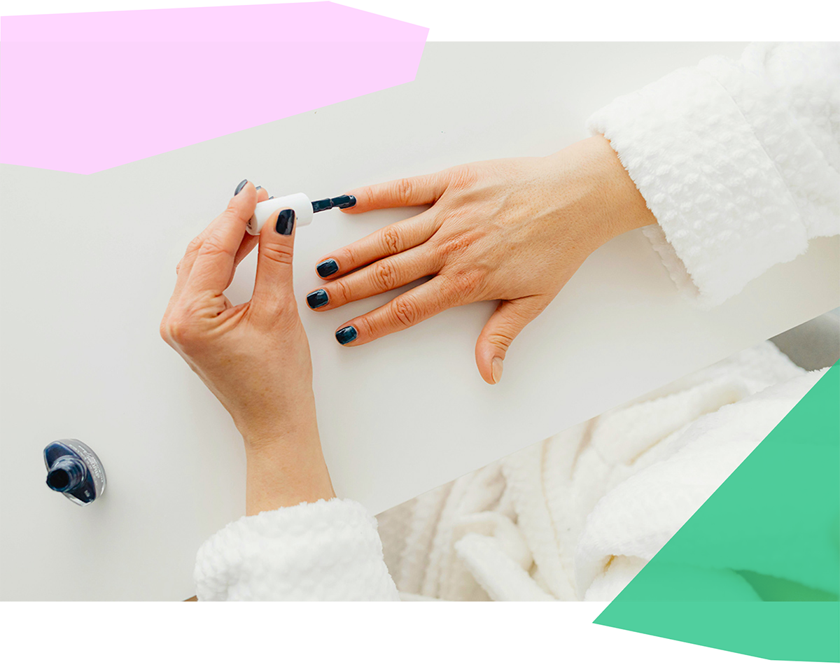 Top view of a woman painting her nails 