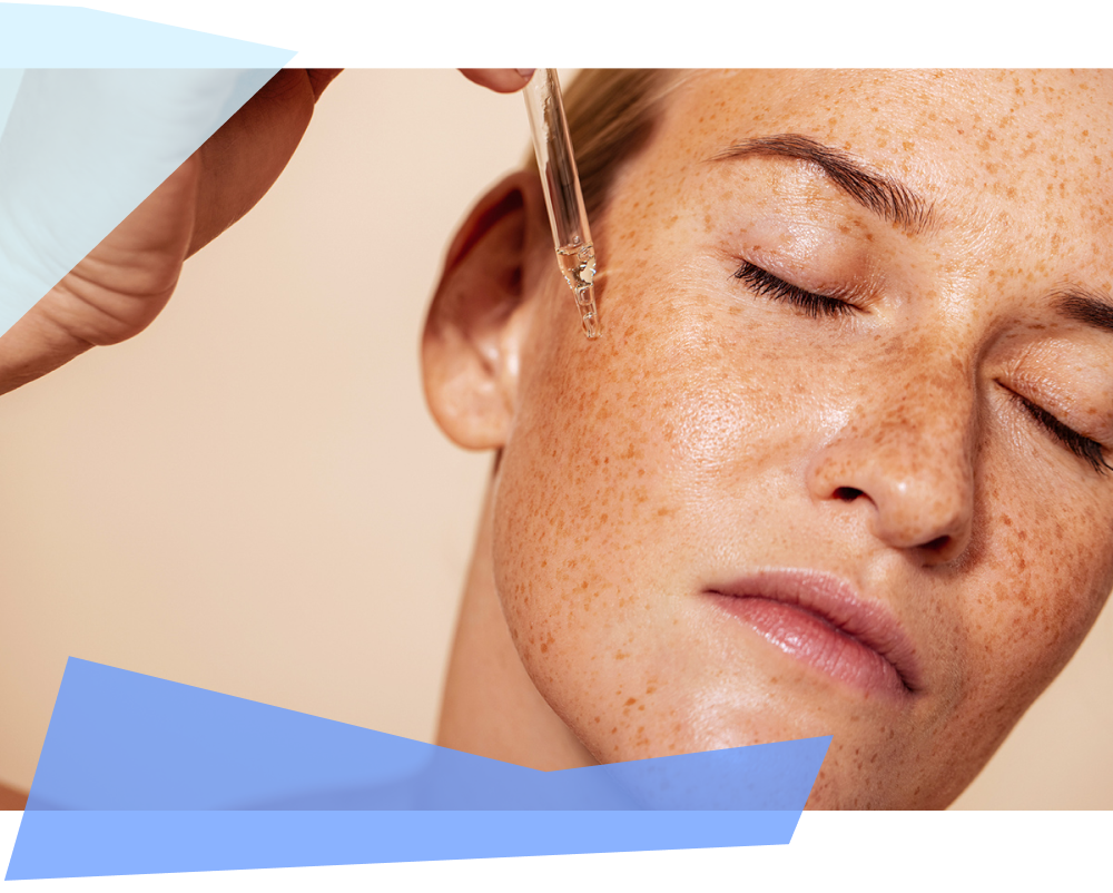 Woman with closed eyes applying face serum with pipette 