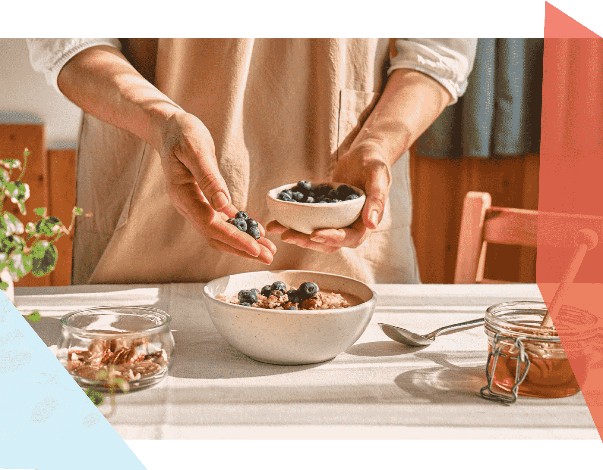 Person adding blueberries to a bowl of oatmeal 