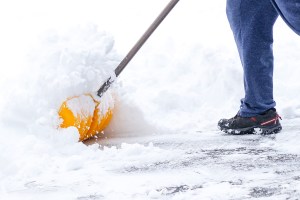 shoveling snow off driveway after a winter storm