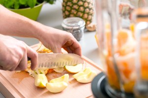 Close-up of apples being chopped on a cutting board