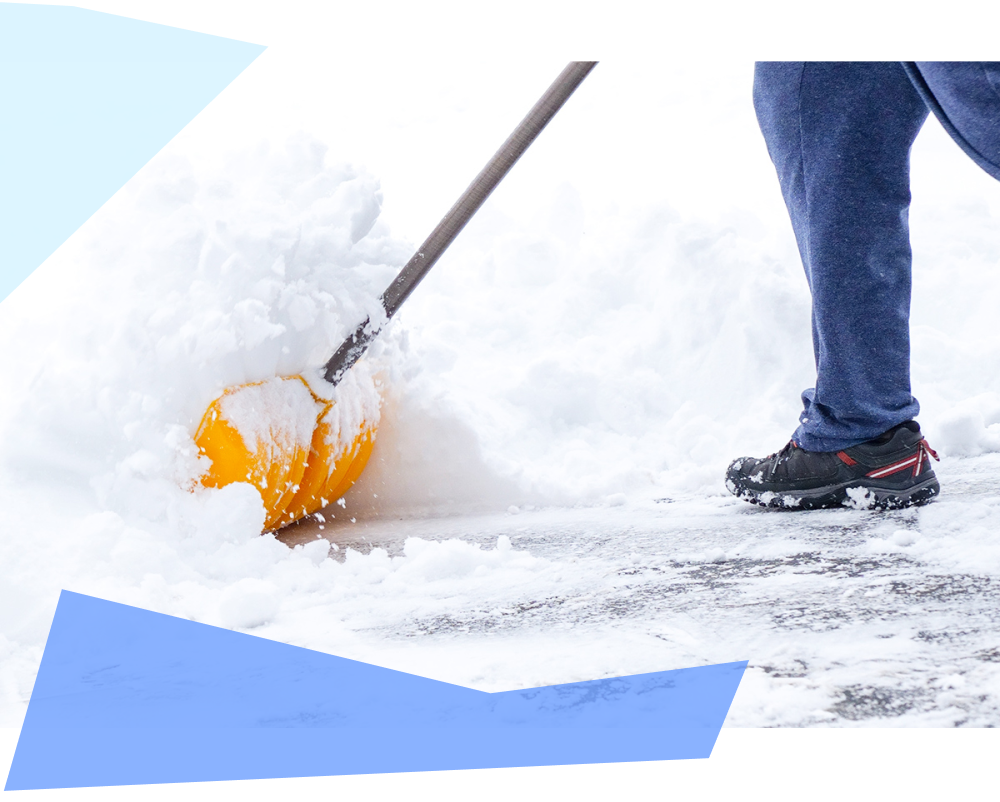 Shoveling snow off driveway after a winter storm 