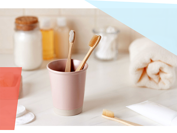 Two toothbrushes in a cup. 