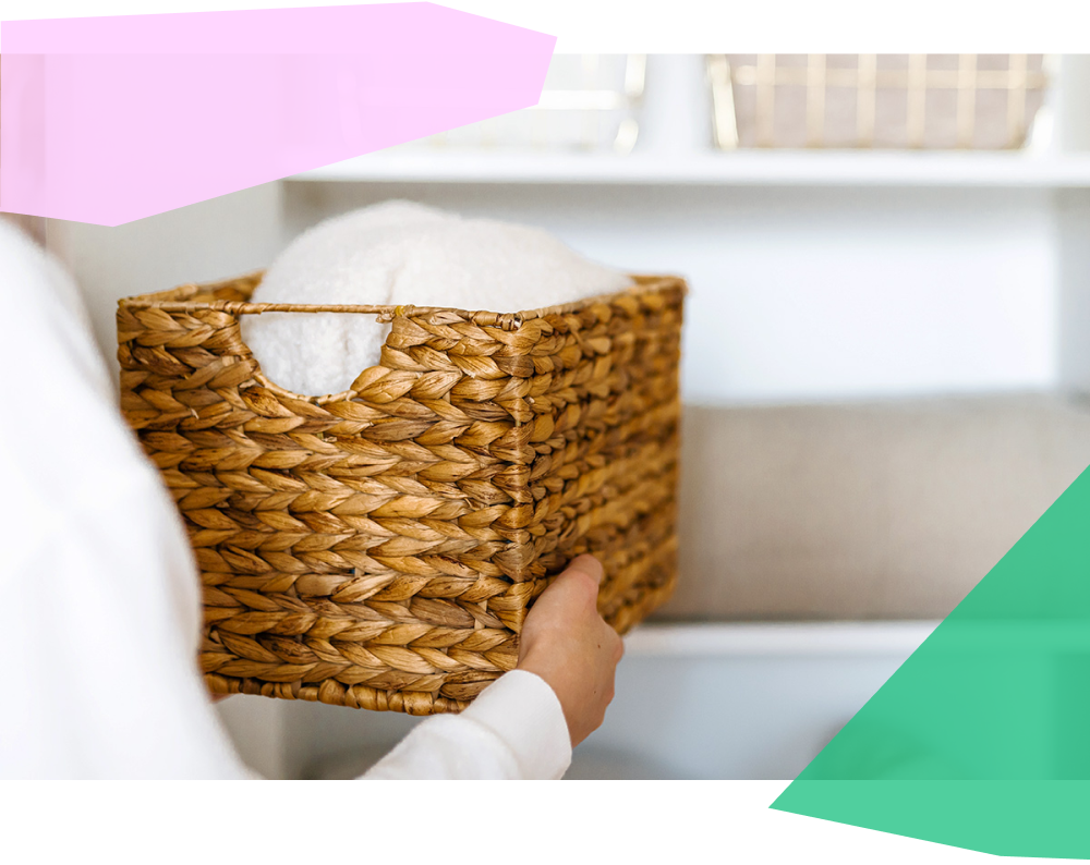 Women organizing shelf in home with wooden basket 