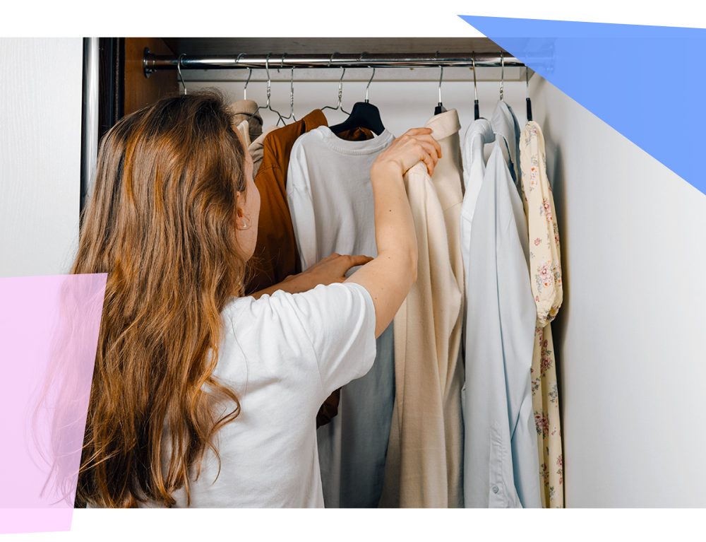 Woman choosing clothing from her closet 