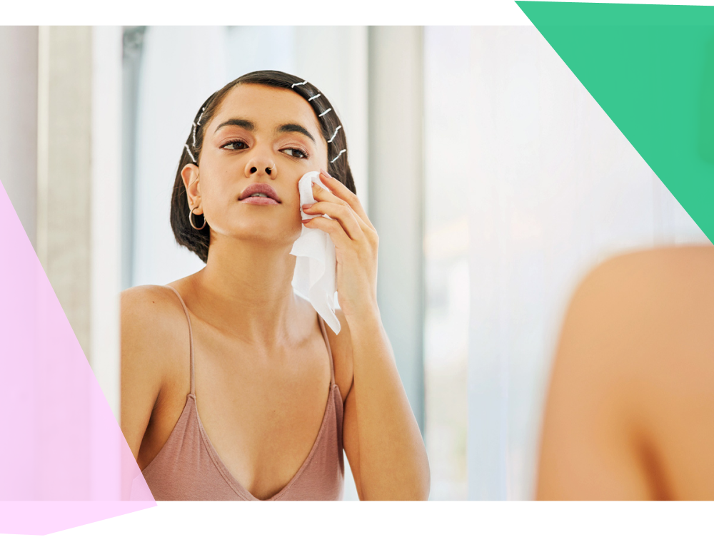 Woman taking off makeup with a wipe 