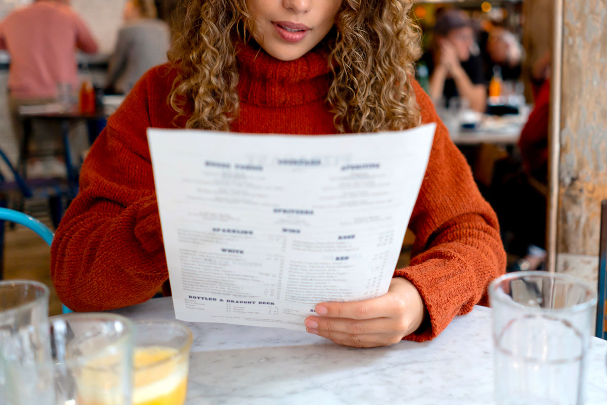 Woman reading a menu at a restaurant 