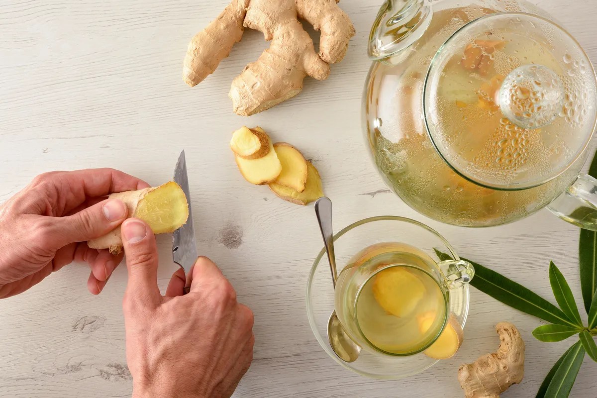 Person slicing ginger 
