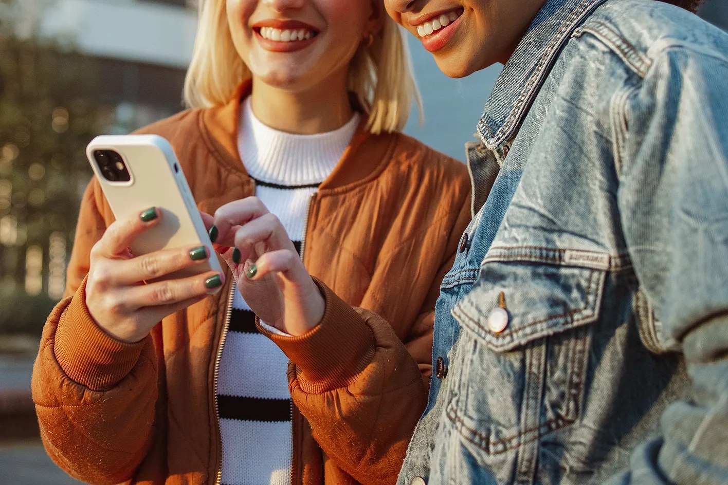 Two women looking at a phone 
