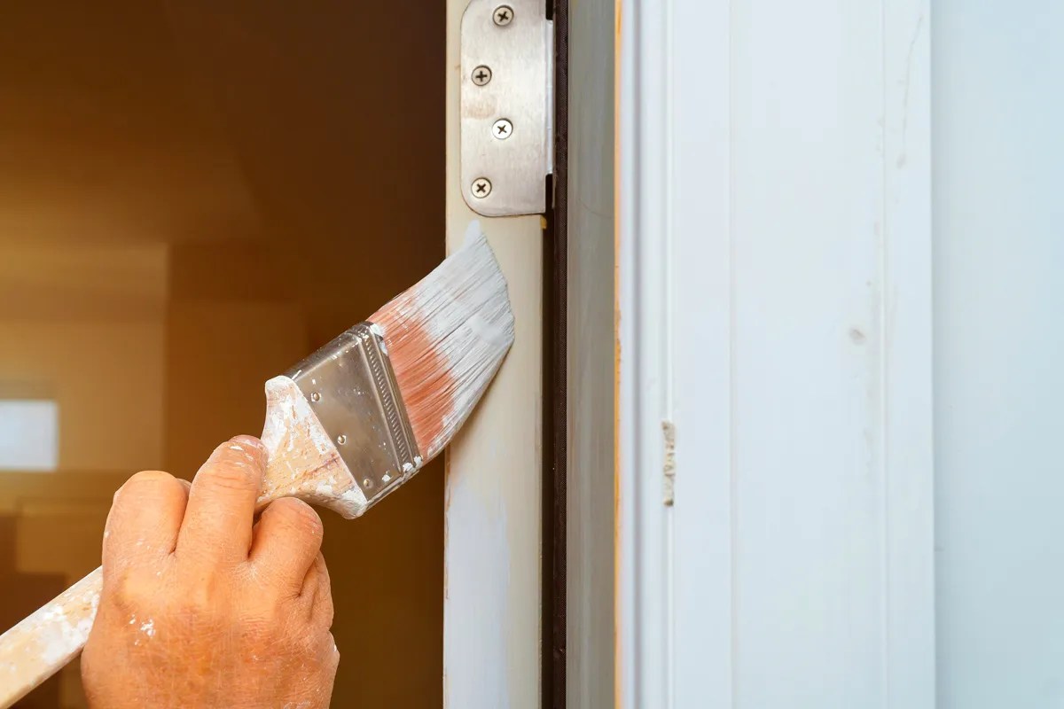 Someone painting a door