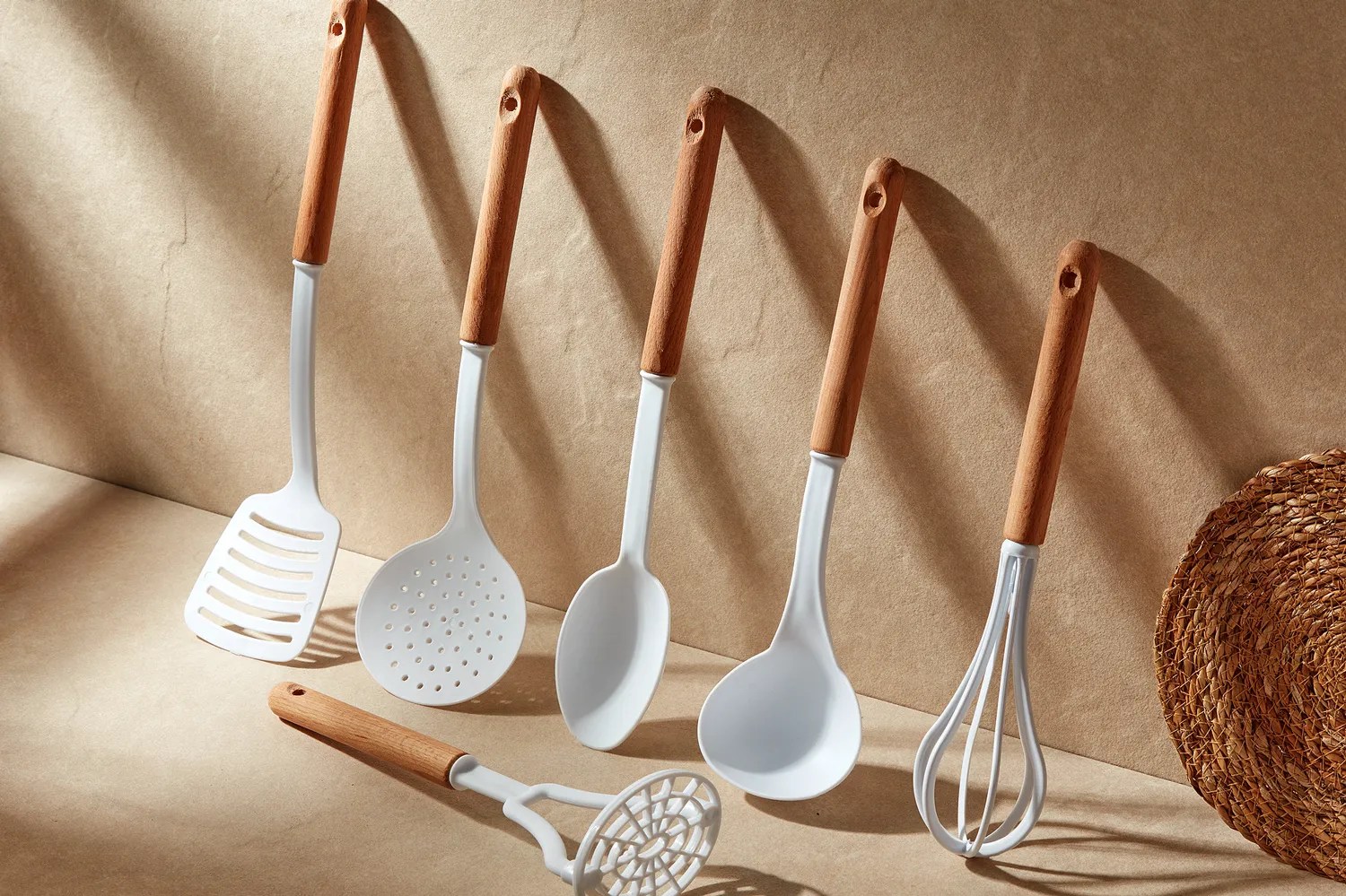 A collection of kitchen tools in white and wood 