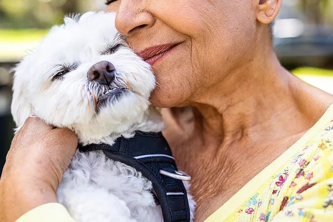 Senior woman holding a dog 